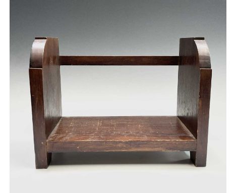 A Glasgow School Arts and Crafts mahogany book trough, the end panels carved with Mackintosh style flowers, width 31cm.
