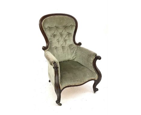 A Victorian walnut framed button back armchair, with scroll end arms and raised on cabriole front legs, height 107cm, width 7