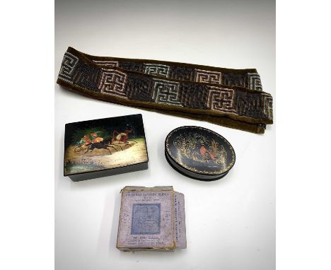 A Russian lacquer box, painted with a troika scene, width 15.5cm, together with a similar oval box, a set of magic lantern sl