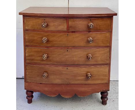 A Victorian mahogany bow front chest of two short and three long drawers, on turned feet, height 113cm, width 107cm, depth 54
