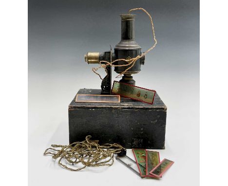A late 19th century tin plate and brass magic lantern by Ernst Plank, overall height 27cm, contained in original box with sev