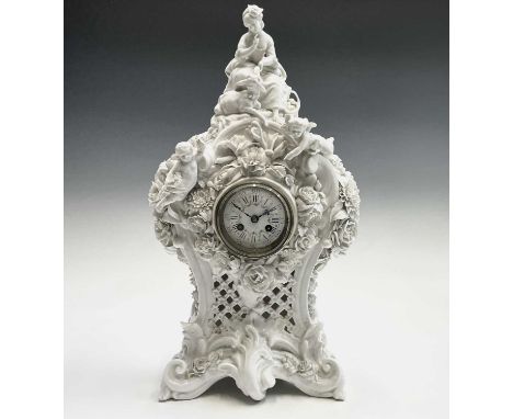 A 19th century French porcelain cased mantel clock by Vion &amp; Baury, surmounted by a shepherdess, cherubs etc, the movemen