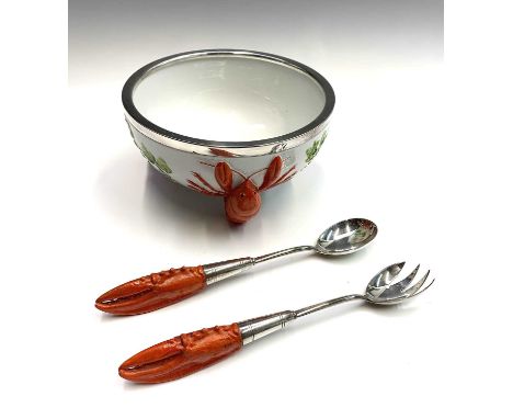 A continental 'lobster' design ceramic salad bowl with silver plated rim, together with a pair of matching silver plated serv