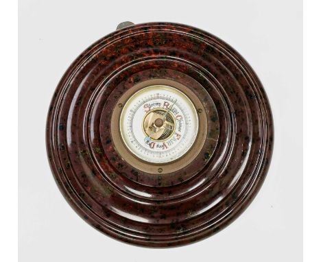 A Cornish red serpentine cased aneroid barometer, circa 1900, with small enamel dial, the mount with turned decoration, diame