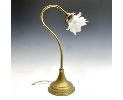 A brass swan neck desk or table lamp, early 20th century, with moulded glass flowerhead shade and on a circular base, height 