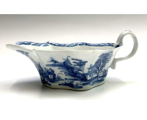 A good Bow sauceboat circa 1750, underglaze painted in blue with buildings in a rural landscape. Height 5.5cm, length 18.5cm.