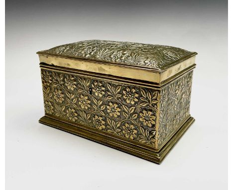 A late19th/early 20th century brass tea caddy of rectangular form with embossed flower head decoration, fitted with two lidde