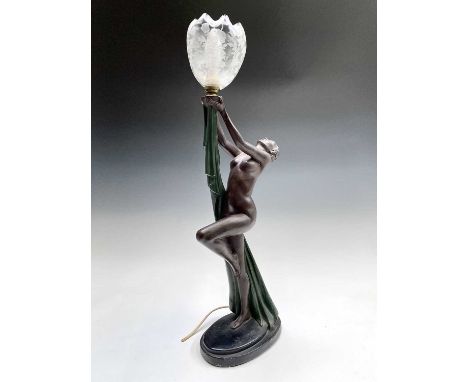An Art Deco style painted plaster table lamp, modelled as a female nude, supporting the lamp in her outstretched arms, height