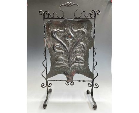 An Arts and Crafts copper and wrought iron firescreen, embossed with stylised foliate decoration. Height 84cm, width 52cm, de