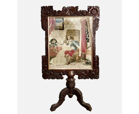 A 19th century Berlin woolwork and mahogany firescreen, the frame carved with foliage, height 127cm, width 73cm.