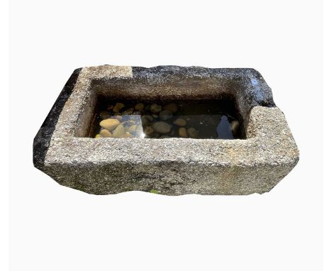 A large granite trough of rectangular form. Height 35cm, width 92cm, depth 55cm.Condition report: the black marking on some o