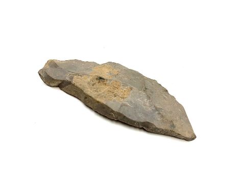 A mesolithic period blade tool. Length 9cm. Provenance: Ex Dr Weller collection.