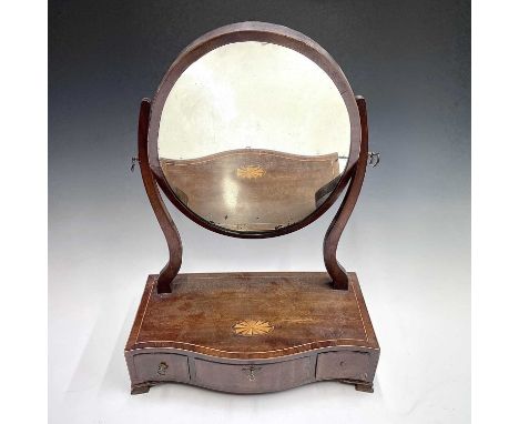 A George III mahogany oval dressing table mirror, with fan inlaid serpentine shaped base fitted with three drawers, height 58