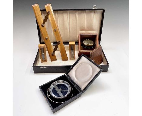 A dry card travelling gimbal compass, circa 1900, brass cased in wooden travel box, the compass diameter 6.5cm, the case widt