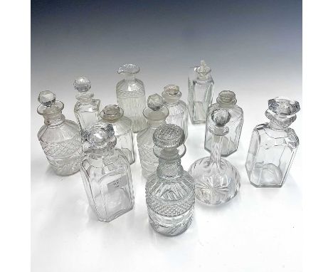 A set of three Victorian octagonal decanters and stoppers, height 15.5cm, together with a pair of lipped decanters and stoppe