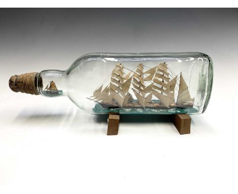 Mark Penrose, a large model ship in bottle, with a four master schooner, with a further fishing boat alongside and one other 