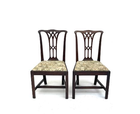 A pair of George III mahogany dining chairs of Chippendale design, with drop-in seats on square chamfered legs.Provenance:Mic