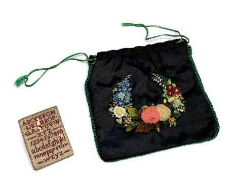 A 19th century miniature alphabet sampler, 5.5cm x 4cm, together with a late 19th/early 20th century small drawstring bag emb