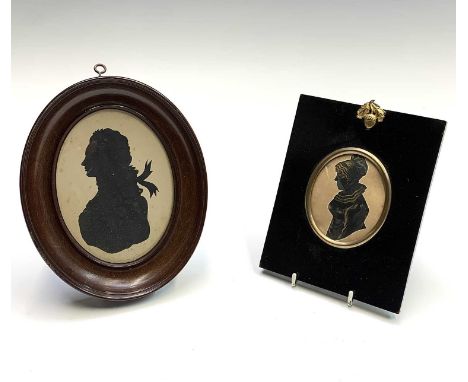 A 19th century oval silhouette portrait of a lady, in rectangular ebonised frame with acorn hanger, 16cm x 12.5cm overall, to