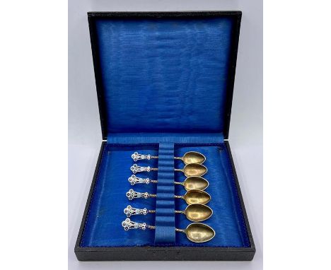 A boxed set of silver and enamel coffee spoons