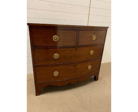 A mahogany chest of drawers with brass ring handles (H94cm W107cm D55cm)