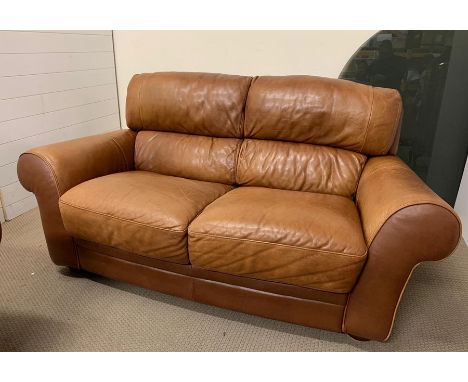 A two seater tan Italian leather sofa by Sofaitalia 