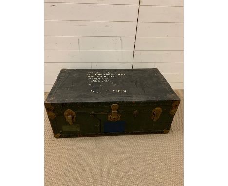 A vintage travel trunk with leather handles and brass corners  
