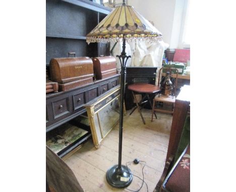 A metal lamp standard, with Tiffany style leaded glass shade, height 62ins
