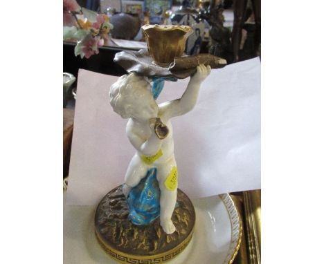 A Moore porcelain candlestick, formed as a putti riding a sea serpent holding a lily pad, af, height 9ins, together with a Mi