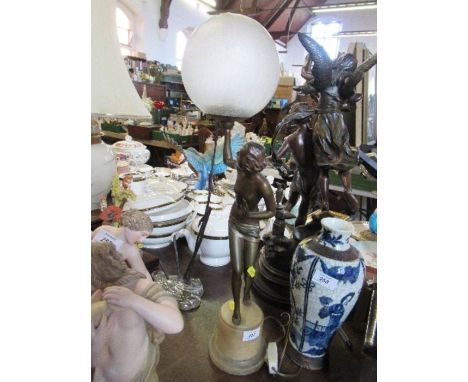 A 20th century spelta lamp base, formed as a semi naked female supporting a frosted crackled glass ball shape, on a cylindric
