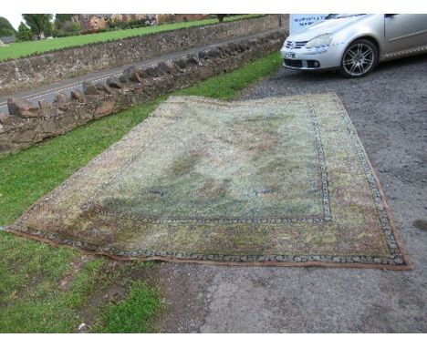 A large Eastern design rug, decorated with animals hunting with foliage, 2 inch hole, 103ins x 145ins