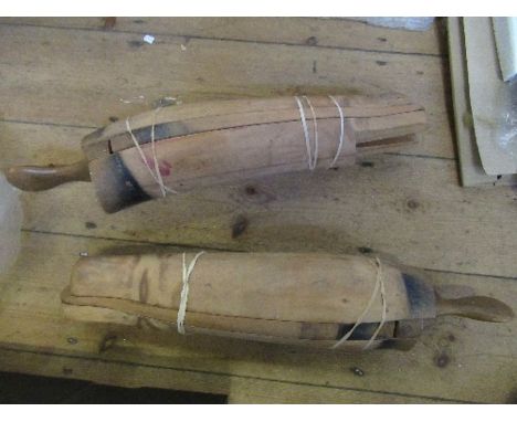 A pair of wooden boot trees, in three sections, marked L and R, missing the foot sections