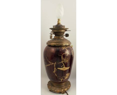 A Hinks's Duplex No.2 oil lamp, now converted to electricity, the dimpled body decorated in gilt to a dark ground, height 26i