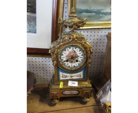 A gilt metal and porcelain mantel clock, the porcelain panels decorated with cherubs and flowers, height 15.5ins - There is n