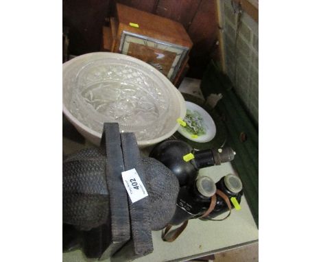 A collection of sundries to include tribal bookends, mantle clock, collectors plates, glass, binoculars, angle lamp, etc.
