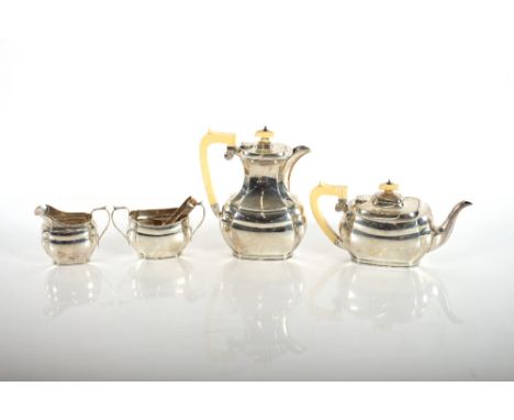 A matched silver three piece tea set, of octagonal panelled form, comprising a teapot Chester 913, a hot water jug Birmingham