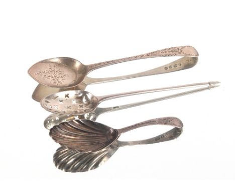 An 18th Century silver mote spoon, the bowl with pierced crosslets; a bright cut decorated Georgian caddy spoon and a bright 