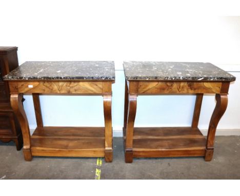 A pair of 19th Century French walnut marble topped console tables, fitted single drawers, raised on shaped front supports and