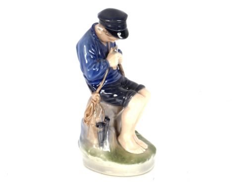 A Royal Copenhagen porcelain figure of a seated fisher boy, 19cm high; and another of a seated girl sewing 14cm high&nbsp;