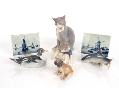 A Royal Copenhagen porcelain figure of a duck; another of a fish; a Bing &amp; Grondahl figure of a seated cat; two 20th Cent