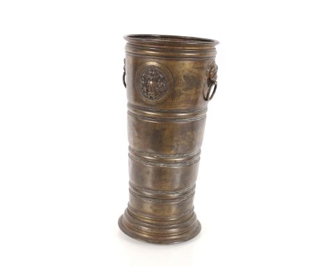 A 19th Century cylindrical brass stick stand flanked by lion mask ring handles, 27cm dia. x 57cm high&nbsp;