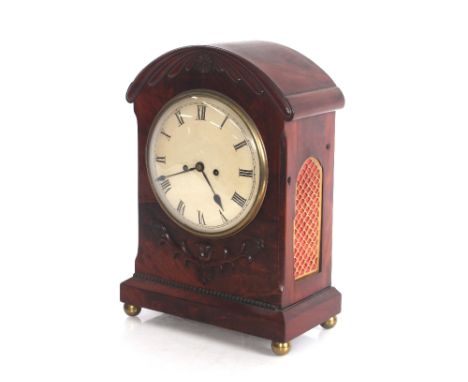 An early 19th Century mahogany bracket clock, the domed case with applied leaf decoration, circular white enamel dial, the ei