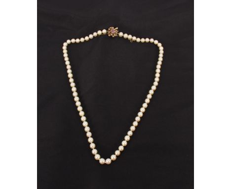 A string of pearls, with 9ct gold ruby coloured and seed pearl inset clasp