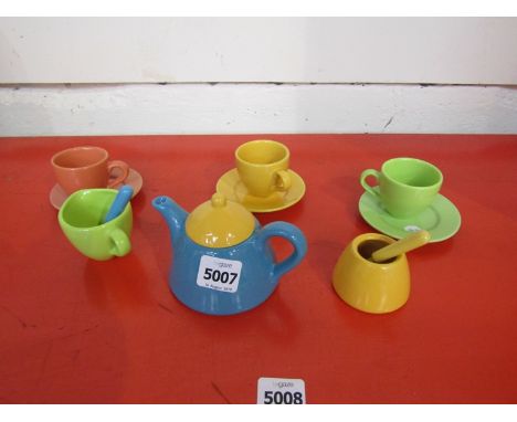 A multi coloured dolls tea service 