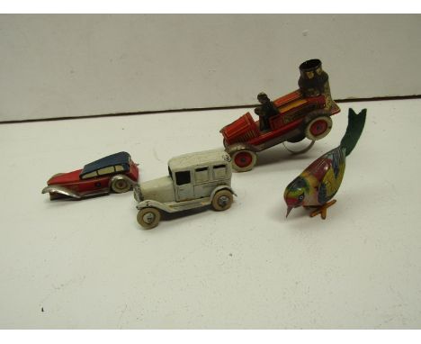A diecast ambulance (possibly pre-war Dinky), together with a tinplate fire engine, bird and saloon car 