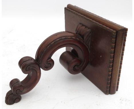 A mahogany wall shelf, the square top with bead edge, on a carved scroll support, width 18ins