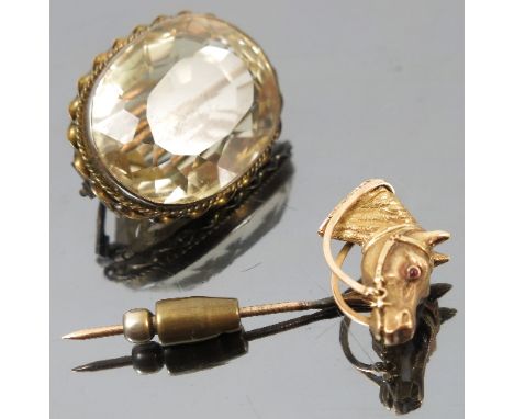 A horse head stick pin, with garnet cabochon eyes, together with a large citrine brooch 