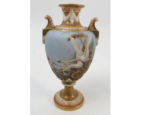 A Royal Worcester vase, decorated with swans to a powder blue ground, by C H C Baldwyn, to lug handles, shape 1432, circa 191