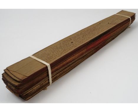 A Ceylonese palm leaf manuscript, with gilt and red edges to the pages