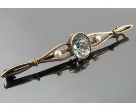 An aquamarine and pearl bar brooch, stamped '9ct', the oval cut stone flanked either side by a button pearl (untested and unw